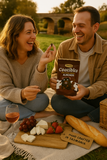 Man and woman enjoying a picnic with Coactibles Almonds and other snacks outdoors.