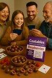 Family playing cards with Coatables chocolate-coated raspberries on a table.