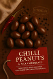 Chilli peanuts in milk chocolate with a red tag on a brown background