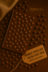 Chocolate bar with cocoa puffs and a tag labeled 'Double Chocolate Cocoa Puff Bar' on a brown background.