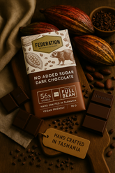 Federation no added sugar dark chocolate bar with cacao beans and a tag on a wooden surface