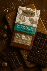 Federation Premium Full Bean Dark Chocolate bar with Tasman sea salt on a wooden board.