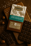 Federation Premium Full Bean Dark Chocolate bar with Tasman sea salt on a wooden board.