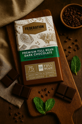 Federation Premium Full Bean Dark Mint Chocolate bar with mint leaves on a wooden surface