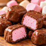 Close-up of Coatibles Marshmallow Softies coated in milk chocolate with a soft raspberry marshmallow centre